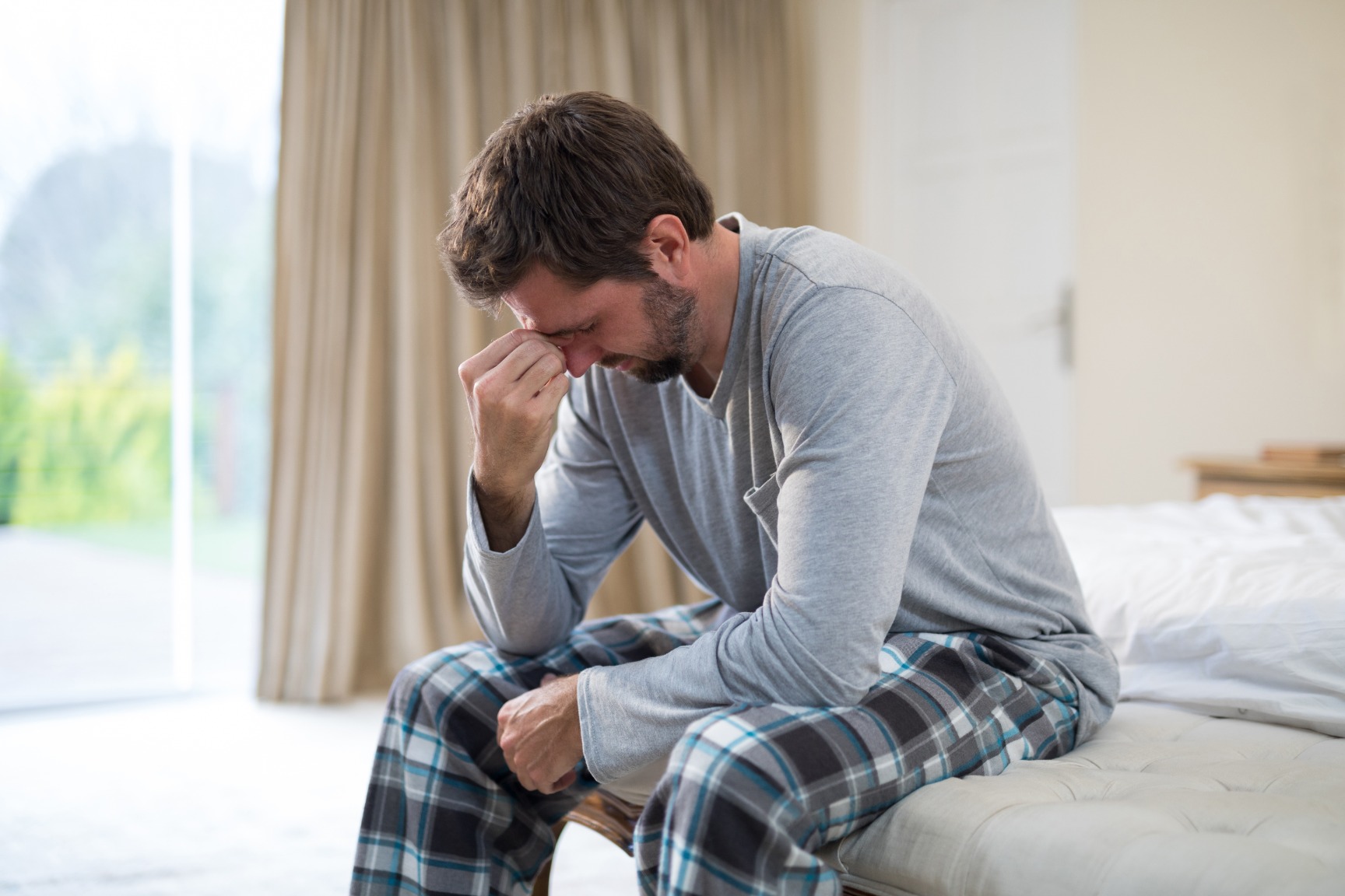 stressed-man-sitting-on-the-bed-CCYX5LF (1)